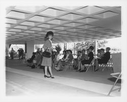 Plaid skirt and jacket ensemble modeled at the fashion show at dedication of parking garage at 3rd and D, Santa Rosa, California, 1964 (Digital Object)