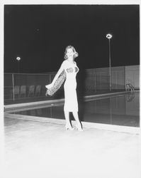 Chonne Patton, Miss Sonoma County, models a white dress with a leopard-print scarf in the Aqua Varieties fashion show at the Swim Center, Santa Rosa, California, 1959 (Digital Object)