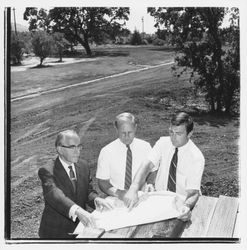 Three men looking at plans for the Tanglewood subdivision, Santa Rosa, California, 1971 (Digital Object)