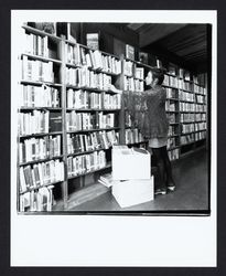 Vicki Boy shelving books at Occidental Library, Occidental, California, 1972 (Digital Object)