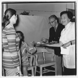 Catering staff person and attendees at the Zumwalt Chrysler-Plymouth Center Open House, Santa Rosa, California, 1971 (Digital Object)