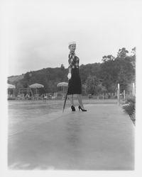 Fringed, plaid top over a black dress modeled in the Dramatic Moods of Autumn Fashion Show, Santa Rosa, California, 1959 (Digital Object)