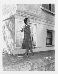 Velvet cocktail dress modeled on the ledge of the Sonoma County Courthouse in downtown Santa Rosa, California, 1959 (Digital Object)