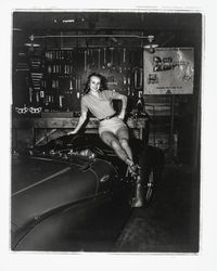 Diane Romero, Miss Sonoma County posing atop a foreign sports car for S.C.C.A. race publicity, Santa Rosa, California, 1957 (Digital Object)