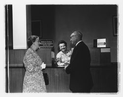 Nellie Urmann issuing travelers checks to a couple at the Exchange Bank, Santa Rosa, California, 1960 (Digital Object)