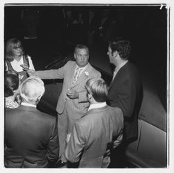 Ed Zumwalt talks to a group of people at the Zumwalt Chrysler-Plymouth Center Open House, Santa Rosa, California, 1971 (Digital Object)
