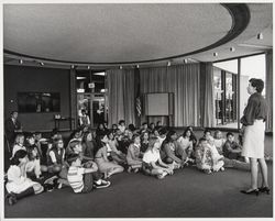 Molly McDermott speaking to a group of children in the Forum Room (Digital Object)