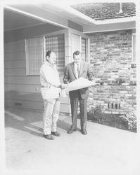 Lewis Meyers and unidentified man inspecting a Meyers built home, Santa Rosa, California, 1960 (Digital Object)