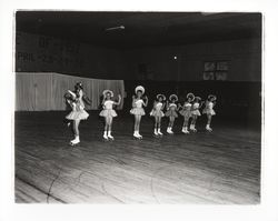 Line of young skaters in bonnets in the Skating Revue of 1957, Santa Rosa, California, April, 1957 (Digital Object)