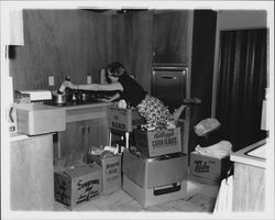 Peck family moving things into their kitchen, Santa Rosa, California, 1957 (Digital Object)