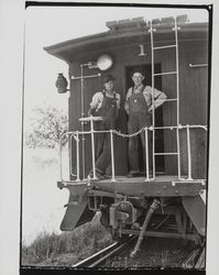 Wayne Williams and Mac McAurich standing at the back of a train, Forestville, California, 1937 (Digital Object)