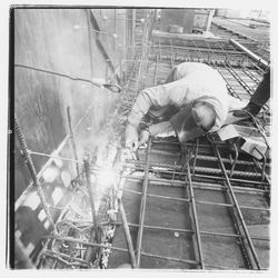 Construction worker welding forms for the second floor in the new Exchange Bank building, 550 Fifth Street, Santa Rosa, California, 1971 (Digital Object)