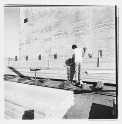 Worker bundling finger-jointed lumber at Speedspace Corporation, 920 Shiloh Road, Windsor, California, 1971 (Digital Object)