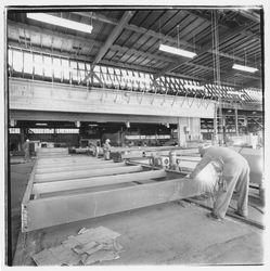 Workers cutting metal framing members to size at Speedspace Corporation, 920 Shiloh Road, Windsor, California, 1971 (Digital Object)