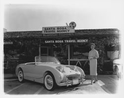 Claire C. Bramwell and her Sprite in front of Santa Rosa Travel, Santa Rosa, California, 1959 (Digital Object)