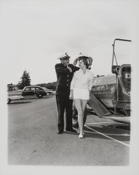 Santa Rosa Fire Chief George H. Magee places a fireman&#39;s helmet on Sandra Duden&#39;s head, Santa Rosa, California, 1958 (Digital Object)