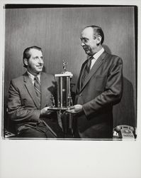 Charles Hall and unknown man with a Little League trophy, Santa Rosa, California, 1971 (Digital Object)