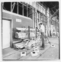 Worker cutting electrical cables at Speedspace Corporation, 920 Shiloh Road, Windsor, California, 1971 (Digital Object)