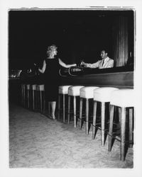 Sleeveless black sack dress modeled in the &quot;Dramatic Moods&quot; fashion show in the Topaz Room, Santa Rosa, California, 1959 (Digital Object)