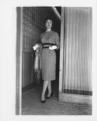 Mid-length dress with a diamond-checked pattern modeled in the &quot;Dramatic Moods&quot; fashion show in the Topaz Room, Santa Rosa, California, 1959 (Digital Object)