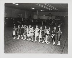 Line of skaters performing a flapper routine in the Skating Revue of 1957, Santa Rosa, California, April, 1957 (Digital Object)