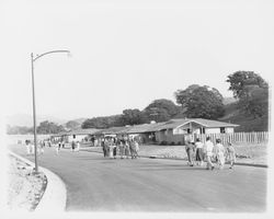 Prospective home buyers walk along Monte Verde Drive to view Saint Francis Acres model homes, Santa Rosa, California, 1958 (Digital Object)