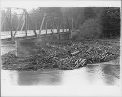 Logs and debris at a Russian River bridge after a flood, Guerneville, California(?), 1937 (Digital Object)