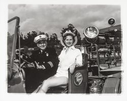 Miss Sonoma County, Sandra Duden, and Santa Rosa Fire Chief George H. Magee in the Santa Rosa 20-30 Club&#39;s old fire engine, &quot;Engine Co. no. 50,&quot; Santa Rosa, California, 1958 (Digital Object)