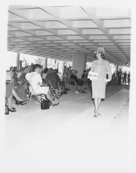 Knee-length, patterned dress modeled at a fashion show at dedication of parking garage at 3rd and D, Santa Rosa, California, 1964 (Digital Object)