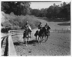 Horseback riders gallop in a corral at Palomino Lakes, Cloverdale, California, 1961 (Digital Object)