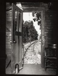 Looking out the door of a caboose of the Petaluma and Santa Rosa Railroad, Petaluma, California, 1937 (Digital Object)