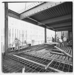 Construction worker pumping concrete into forms for the second floor in the new Exchange Bank building, 550 Fifth Street, Santa Rosa, California, 1971 (Digital Object)
