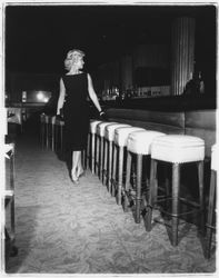 Black sleeveless dress modeled in the &quot;Dramatic Moods&quot; fashion show in the Topaz Room, Santa Rosa, California, 1959 (Digital Object)