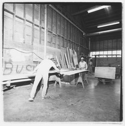 Workers trim sheets of plywood at Speedspace Corporation, 920 Shiloh Road, Windsor, California, 1971 (Digital Object)