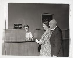 Nellie Urmann issuing travelers checks to a couple at the Exchange Bank, Santa Rosa, California, 1960 (Digital Object)