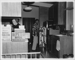 Peck family moving things into their kitchen, Santa Rosa, California, 1957 (Digital Object)