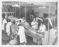 Workers bagging chickens at the California Poultry, Incorporated, Fulton, California, 1958 (Digital Object)
