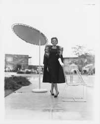 Black coat with a fur stole modeled in the Dramatic Moods of Autumn fashion show, Santa Rosa, California, 1959 (Digital Object)