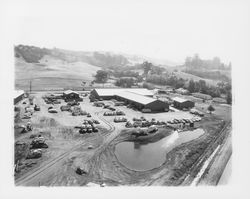 Aerial view of graded equipment yard and pond at the rear of Stevenson Equipment Company Incorporated, Santa Rosa, California, 1964 (Digital Object)