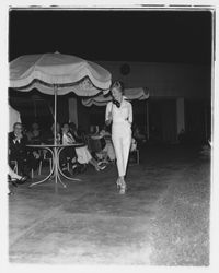 White leisure pants and matching white, long-sleeved blouse modeled at the Sword of Hope fashion show at the Flamingo Hotel, Santa Rosa, California, June 18, 1960 (Digital Object)