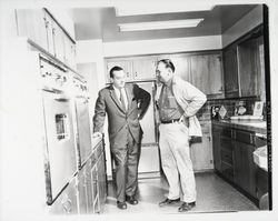 Lewis Meyers and unidentified man inspecting a Meyers built home, Santa Rosa, California, 1960 (Digital Object)