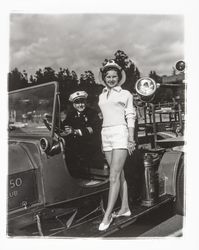 Miss Sonoma County, Sandra Duden, and Santa Rosa Fire Chief George H. Magee on the Santa Rosa 20-30 Club&#39;s old fire engine, &quot;Engine Co. no. 50,&quot; Santa Rosa, California, 1958 (Digital Object)