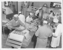 Workers boxing bagged chickens at the California Poultry, Incorporated, Fulton, California, 1958 (Digital Object)