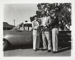 Dutch Flohr and two others standing near a City of Santa Rosa car, Santa Rosa, California, 1959 (Digital Object)