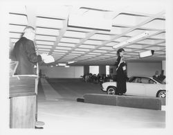 Black evening dress modeled in a fashion show at dedication of parking garage at 3rd and D, Santa Rosa, California, 1964 (Digital Object)